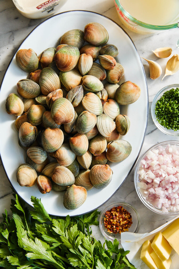 Garlic Butter Clams with White Wine Cream Sauce - The BEST steamed clams ever! So garlicky and buttery, served with a heavenly cream sauce!